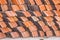 Abstract piles and packs of a new clay ceramic tiles to cover the roof of a Buddhist temple. Stack of new orange roof tiles in the