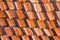 Abstract piles and packs of a new clay ceramic tiles to cover the roof of a Buddhist temple. Stack of new orange roof tiles in the