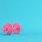 Abstract pink dumbbell on bright blue background in pastel color