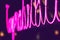 Abstract pink neon sign with blurred neon tube light background