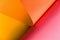 Abstract pink, orange and yellow papers bending together in abstract form. Abstract color paper background
