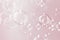 Abstract pink valentine` day background. Beautiful blur transparent soap bubbles float on pink background.