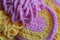 Abstract Pink and yellow background with soft yarn of baby colors, crocheted texture pattern, female hobby