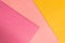 Abstract pink and yellow papers stacking together in abstract form. Abstract color paper background