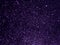 Abstract purple glitter light shiny background. Beautiful dark starry sky.