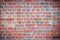 Abstract red brick old wall texture background. Ruins uneven crumbling red brick wall background texture.