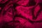Abstract red purple creasy velvet fabric background texture. beautiful luxurious fabric for draperies, curtains, bed cover, love