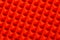 Abstract red silicone pyramids array close-up background