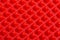 Abstract red silicone pyramids array close-up background