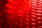 Abstract red silicone pyramids mat close-up background with selective focus and blur