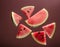 Abstract representation of watermelon pieces cut into various shapes, floating freely
