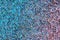 Abstract rhinestones background. Texture of rhinestones illuminated with multi-colored light. Pink and blue shine