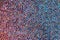 Abstract rhinestones background. Texture of rhinestones illuminated with multi-colored light. Pink and blue shine