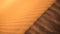 Abstract ripple texture of orange sand dune ridge
