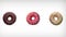 Abstract rotation animation of of three different colorful donuts on white background.