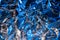 Abstract rumpled foil texture background. Futuristic bright neon blue and silver texture