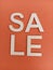 Abstract sale sign on an orange background