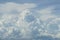 Abstract scene of powerful free form white cloud with shades of blue sky background