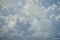 Abstract scene of powerful moving white cloud with shades of blue sky background