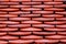 Abstract scene of Red earthenware tiles or calls tiles consists of fish scales on the roof of temple bangkok thailand