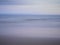 Abstract shades of blue and violet beach over the ocean. Deliberate in camera movement