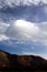 Abstract shaped  towering dense wave like cumulus cloud over mountain peak on Canary Islands, Tenerife