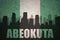 Abstract silhouette of the city with text Abeokuta at the vintage nigerian flag