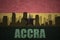 Abstract silhouette of the city with text Accra at the vintage ghanaian flag
