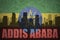 Abstract silhouette of the city with text Addis Ababa at the vintage ethiopian flag