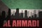 Abstract silhouette of the city with text Al Ahmadi at the vintage kuwait flag