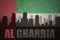 Abstract silhouette of the city with text Al Gharbia at the vintage united arab emirates flag