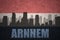 Abstract silhouette of the city with text Arnhem at the vintage dutch flag