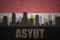 Abstract silhouette of the city with text Asyut at the vintage egyptian flag