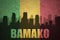 Abstract silhouette of the city with text Bamako at the vintage malian flag