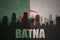 Abstract silhouette of the city with text Batna at the vintage algerian flag