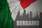 Abstract silhouette of the city with text Bergamo near waving national flag of italy on a gray background