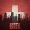 Abstract silhouette of the city with text Biel at the vintage swiss flag