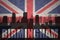 Abstract silhouette of the city with text Birmingham at the vintage british flag