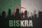 Abstract silhouette of the city with text Biskra at the vintage algerian flag