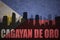 Abstract silhouette of the city with text Cagayan de Oro at the vintage philippines flag