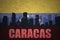 Abstract silhouette of the city with text Caracas at the vintage venezuelan flag