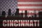 Abstract silhouette of the city with text Cincinnati at the vintage american flag