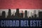 Abstract silhouette of the city with text Ciudad del Este at the vintage paraguayan flag