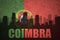 Abstract silhouette of the city with text Coimbra at the vintage portuguese flag