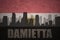 Abstract silhouette of the city with text Damietta at the vintage egyptian flag