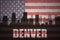 Abstract silhouette of the city with text Denver at the vintage american flag