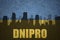 Abstract silhouette of the city with text Dnipro at the vintage ukrainian flag