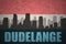 Abstract silhouette of the city with text Dudelange at the vintage luxembourg flag