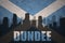 Abstract silhouette of the city with text Dundee at the vintage scotland flag