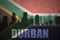 Abstract silhouette of the city with text Durban at the vintage south africa flag